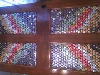 To even out the dips in the door, this crafter used bottle caps to fill the gaps.