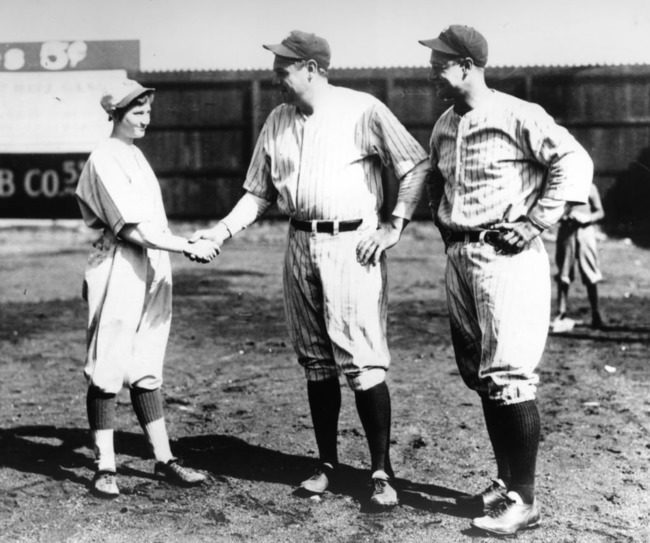 Jackie Mitchell shakes the hands of Babe Ruth and Lou Gehrig. She was the only female in history to strike out both of these baseball legends.