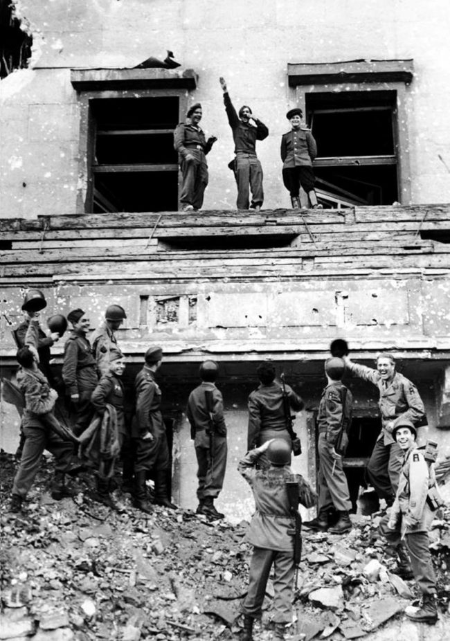 Allied forces mock Hitler from atop his balcony at the Reich Chancellery at the end of WWII.