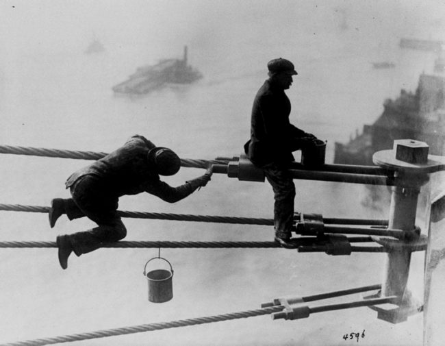 Painters at work high above New York City, painting the Brooklyn Bridge on December 3, 1915.