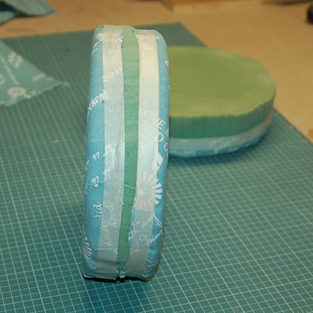 She added some masking tape to ensure the fabric adhered to the foam. 