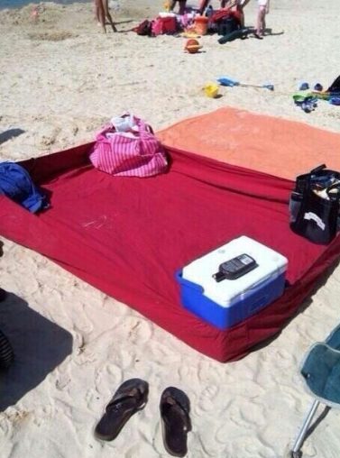 Use a fitted sheet to keep sand off your hangout zone at the beach. Make it taut with your cooler, shoes, and beach bag!