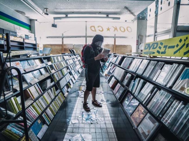 Here he is inside an abandoned video store.