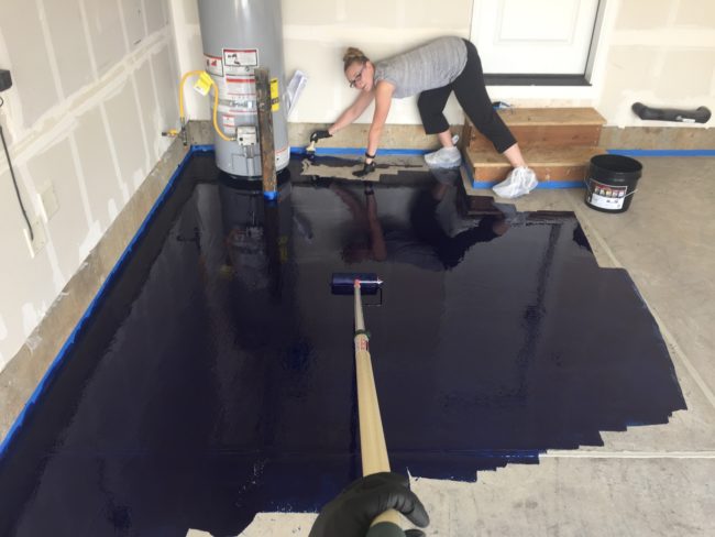 Using a squeegee and some paint rollers, he and his lovely assistant spread the epoxy in smaller patches so they could work with it before it set.