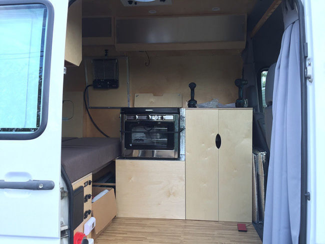 His design included a working oven and a kitchen sink. He also made the decision to house the propane and water tanks inside the van under the oven.