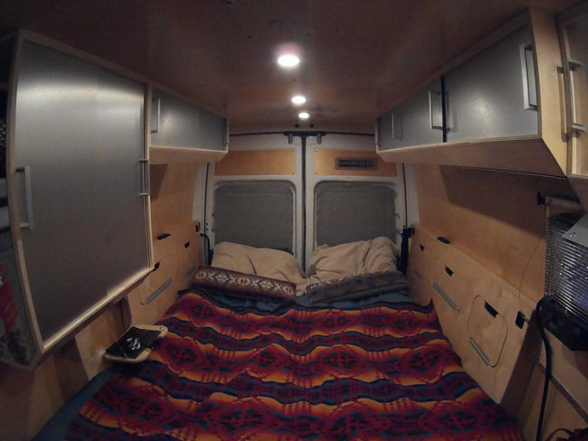 No need for a tent on this camping trip,  this RV has a comfortable bed spread. 