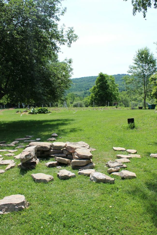 After the pit is secured, add a few rocks to the center as a placeholder for charcoal or firewood.