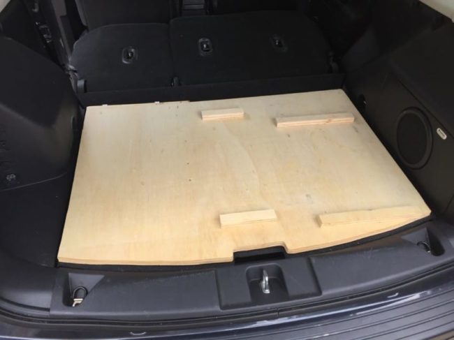 He cut a piece of plywood for a base to work from. Little notches marked where the fridge and drawers would go.