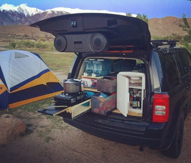 Next to the cabinet, he put more storage bins and an iceless cooler that he plugs into the car's cigarette lighter.