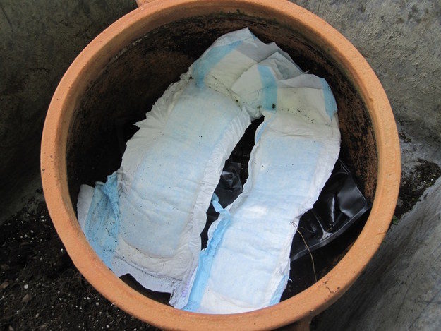 Adding diapers to your pots will hold in moisture, keeping your soil moist for days.