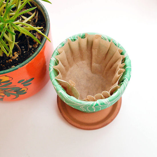 Keep soil from leaking out the bottoms of your pots with a coffee filter.