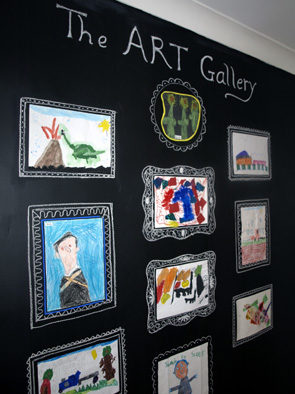 Make your kids proud of their artwork by hanging it on their own <a target="_blank" href="http://artful-kids.com/blog/2011/02/25/chalkboard-gallery/">gallery wall</a>!