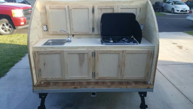 Cabinet doors, a sink, and a stove all went in.