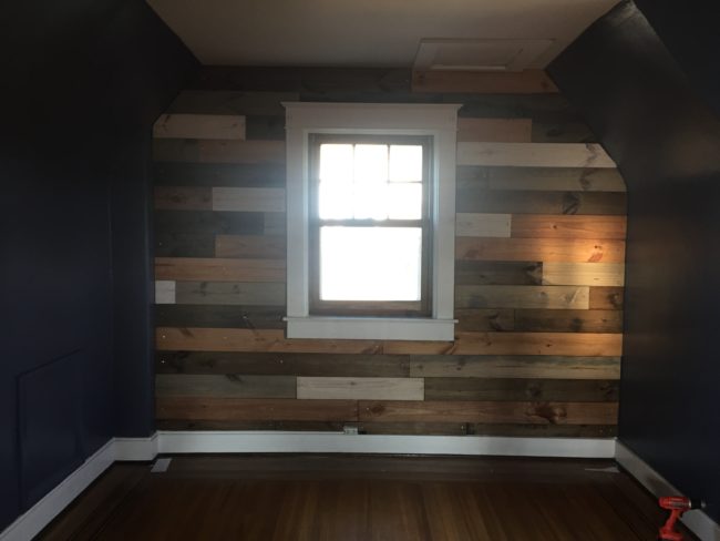 Using just a hammer and nails, our designer attached the wood pieces to the wall.