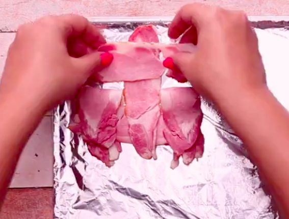 Then pull back the other two slices from the opposite end and place another piece of bacon down.