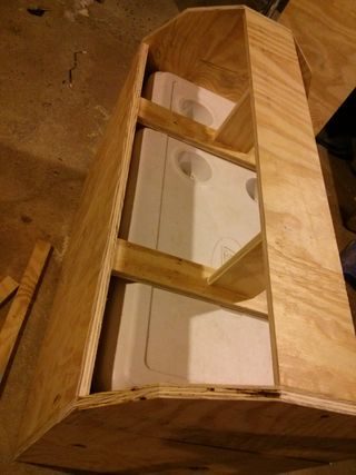 Then, he replaced the cooler lid and attached boards on top for vertical support, screwing the lid onto the cross bracing when he was done.