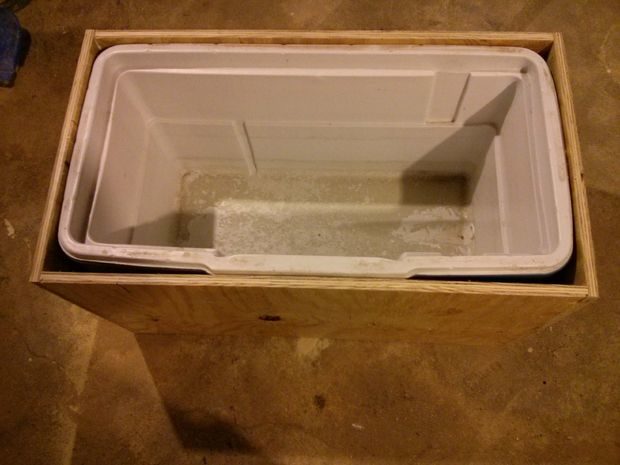 Using the cooler's measurements, he built a snug case out of pine plywood.