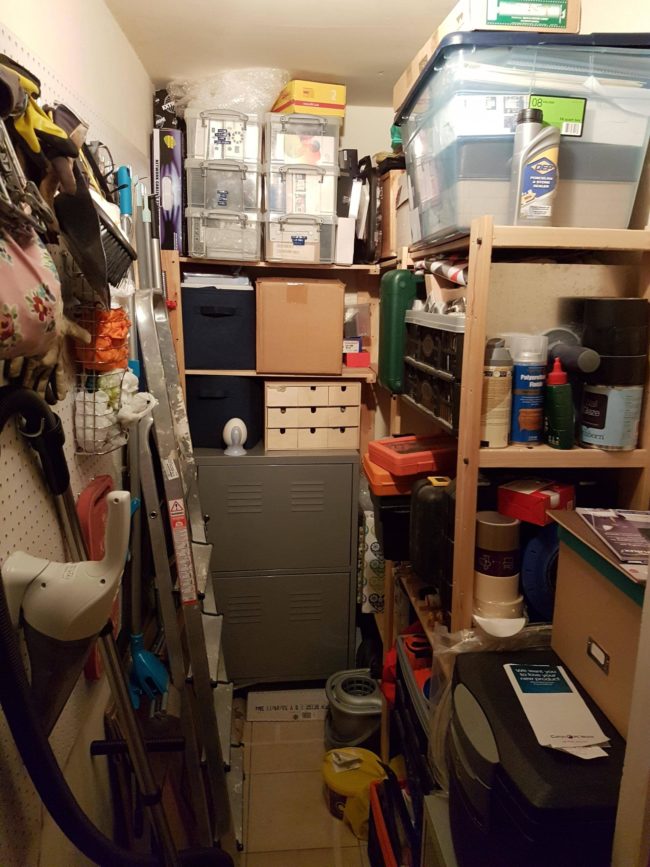 This was the cupboard before he got started -- it's pretty small and very packed.