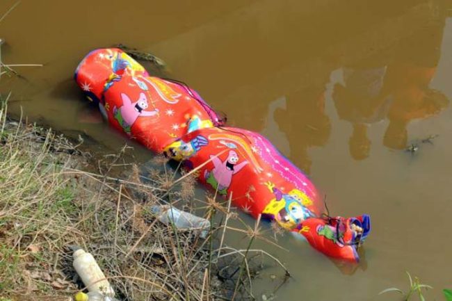 That sure looks like a body rolled up in a sleeping bag. It was found in a city irrigation canal.