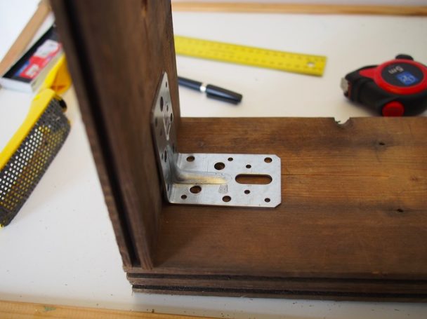 Once he made a rectangle that was the same size as the IKEA tabletop, he attached the boards to each other with L-angles and screws. 