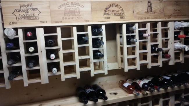 He attached the header to the wine racks and began restocking "the goods."