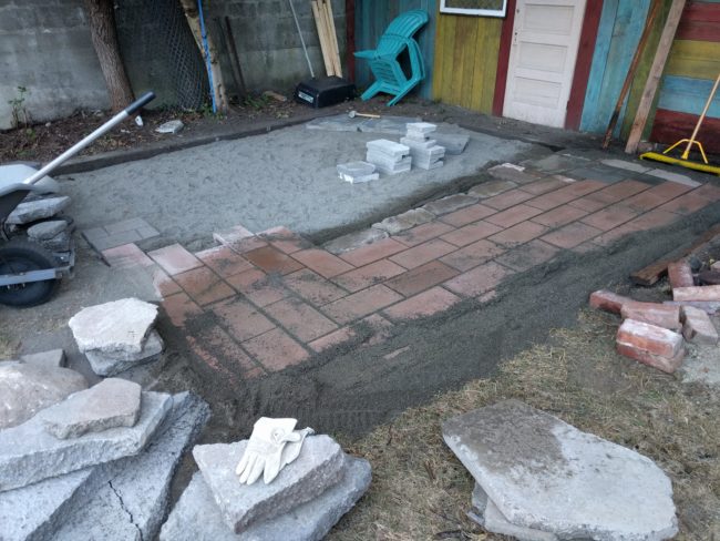 He began laying them, making sure to also sand the areas between the tiles.