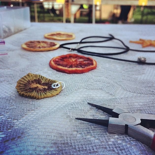 After each piece hardens, she cuts holes in the pendants and attaches string.