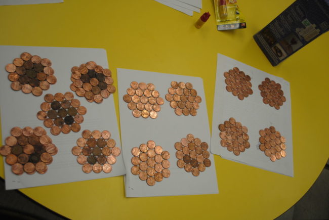 The pieces with the older-looking pennies would be placed between the brighter ones.