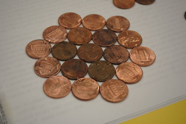 To finish each hexagon, he added a layer of clean pennies around the outside.