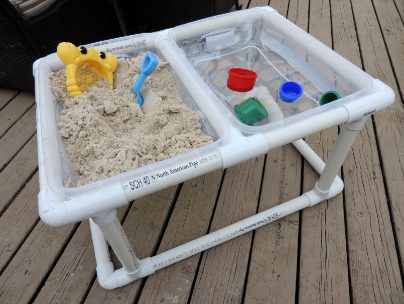 Help babies play in the sand and water without making messes of themselves by recreating this <a href="https://jaxinthebox.com/2013/05/01/diy-sand-water-table-60-minutes-50-done/" target="_blank">cute setup</a>!