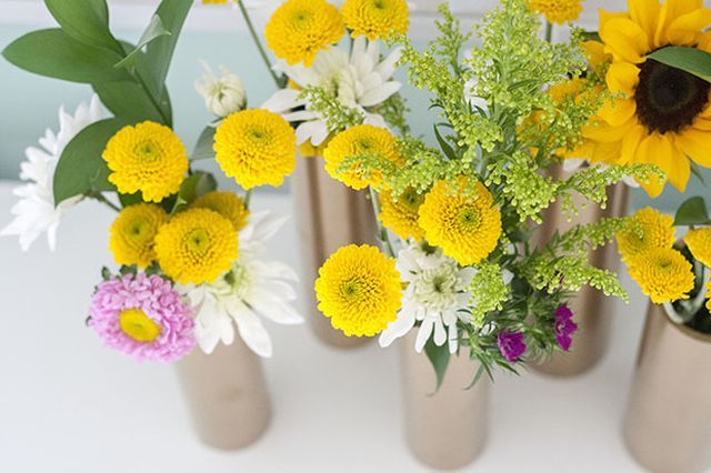 Spray paint PVC pipes with metallic paint to create <a href="http://www.ehow.com/ehow-home/blog/make-a-modern-spring-centerpiece-using-just-gold-spray-paint-and-pvc-pipe/" target="_blank">slim, luxurious vases</a> for centerpieces!