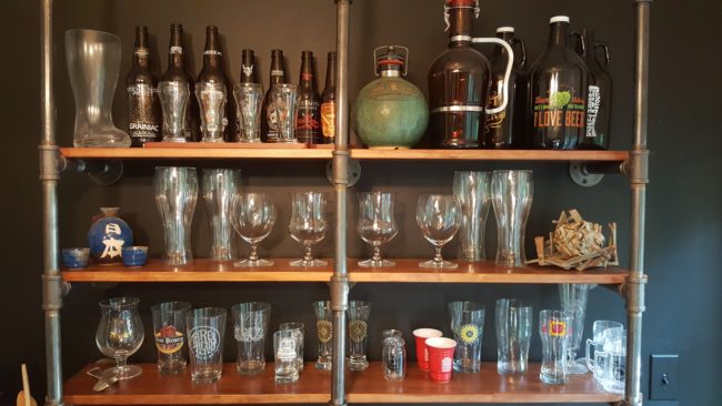 Before mounting the bar, he screwed more piping into the wall and added cheap pine boards to create great-looking shelving that can hold a lot of weight.