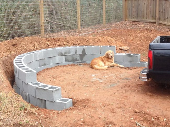 His canine friend wasn't much help, so he had to stack the cement blocks by himself.