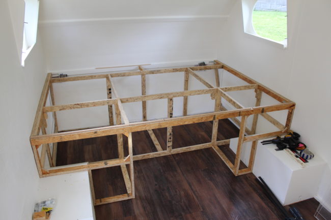 The builder needed a place to sleep, so he began building a bed frame.