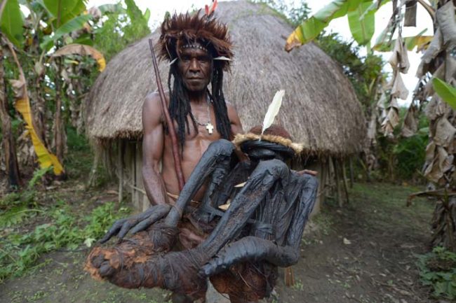 Here, the Dani tribe chief Eli Mabel is holding the remains of his ancestor Agat Mamete Mabel.