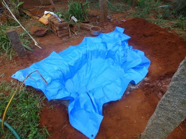 He spread out a pond liner to avoid any water damage to the area.