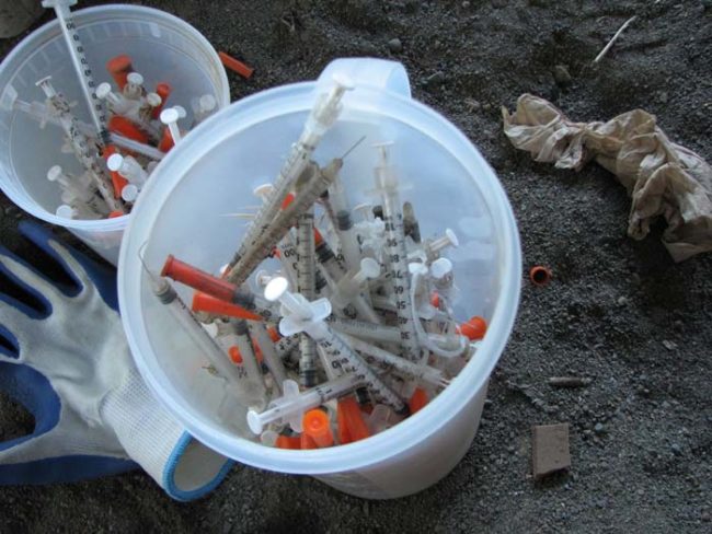 Those are two buckets filled with hypodermic needles collected near an underpass in the University Park neighborhood of Portland.