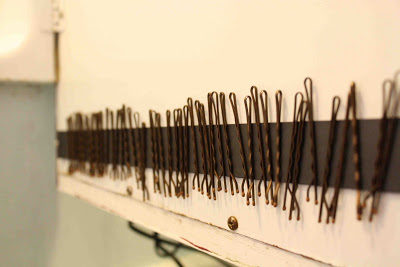 Never lose your bobby pins again by attaching a <a target="_blank" href="http://sprwmn.blogspot.com/2010/11/2-minute-bathroom-organization.html">magnetic strip</a> to the inside of your bathroom cabinet!