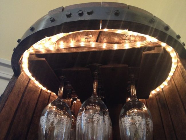 Next he added a wine glass holder and mini wine rack that he found at a secondhand store. A string of LED lights added some much-needed flair.