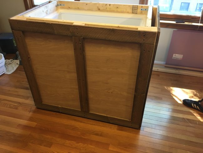 He created a rustic frame to surround the box freezer.