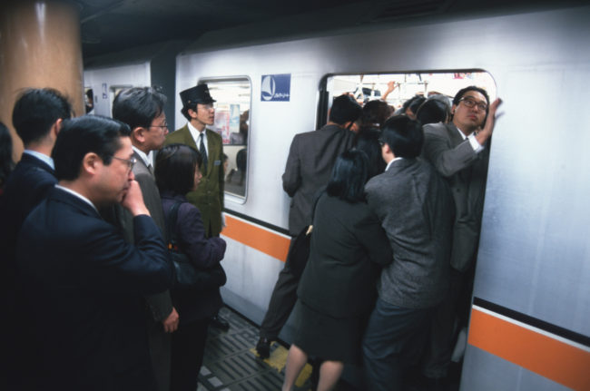 Although this job is a thing of the past, subway workers still have to help push passengers during rush hour.