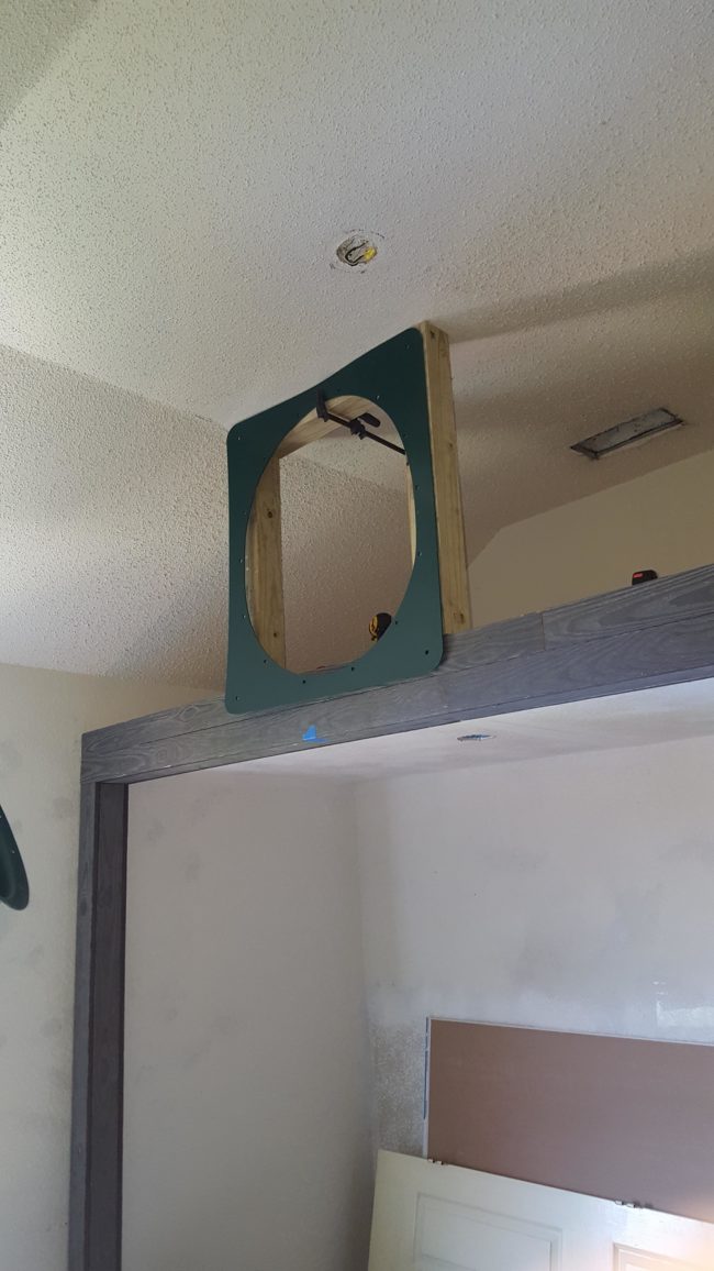 It needed a mount, so he nailed wood planks into the beam and bolted them to the ceiling before attaching the slide.