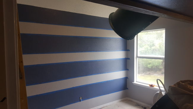 He thought his son would love a nautical theme, so he painted the walls with blue stripes.