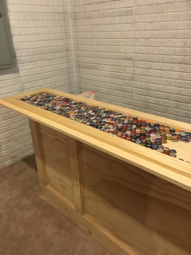 He began laying the caps out to cover the counter.