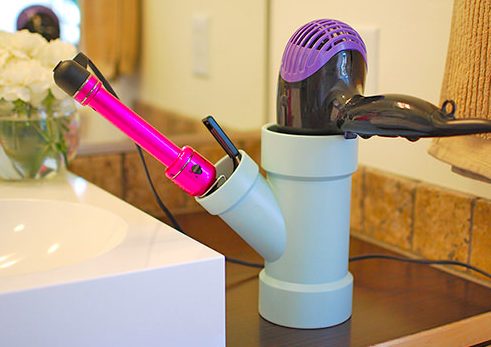 Keep hairdryers and curling irons where they belong with this <a href="http://www.decoratingyoursmallspace.com/14-awesome-pvc-projects-for-the-home/" target="_blank">PVC organizer</a>.