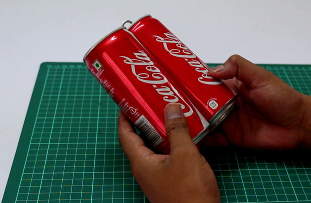 He used these old Coke cans to create the popcorn machine, but any brand would do.