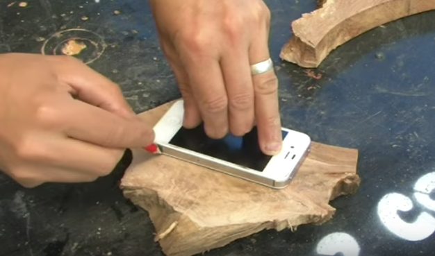 First, he traced his phone onto a slab of wood.
