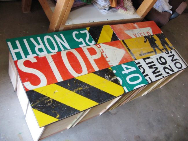 He cut his road signs to fit the drawer faces, creating a gorgeous collage.