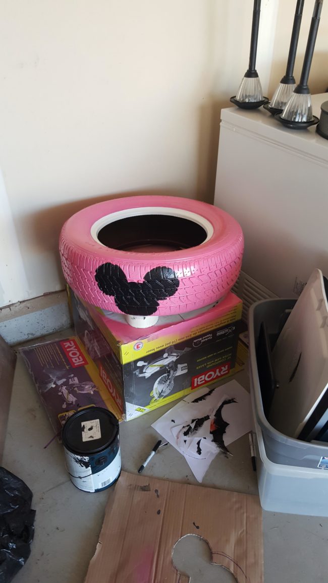 He got to work by spraying it pink and painting the mouse using a cardboard stencil.