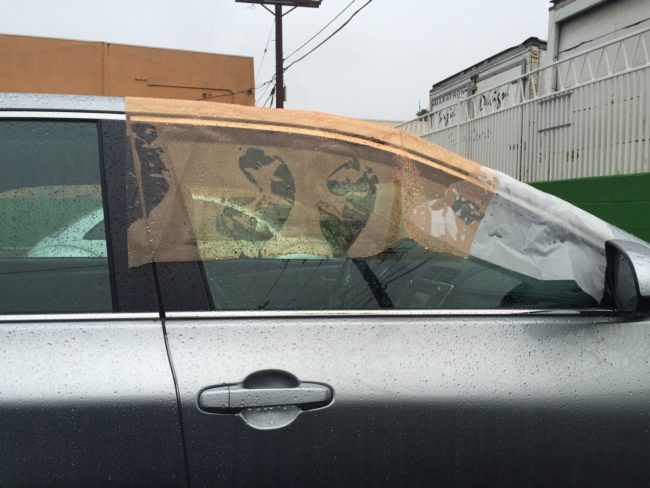 Redditor kestrelrogue saw a car's window rolled down in the rain, so he thoughtfully covered it up.